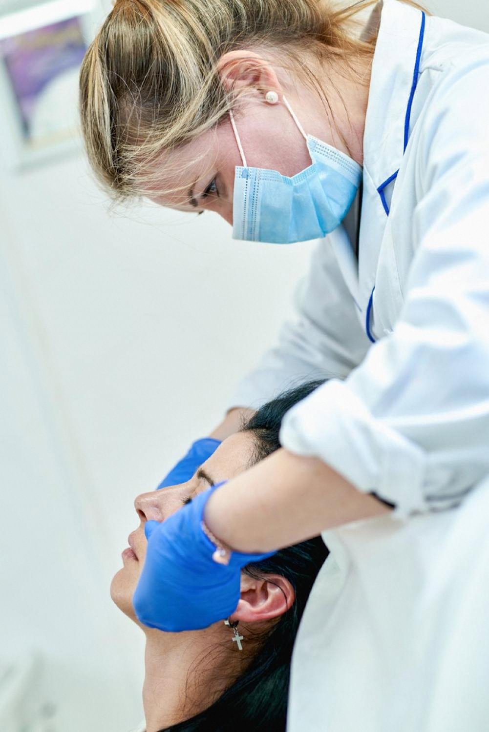 Dermatologist examining a patient's skin during a personalised consultation in Dubai